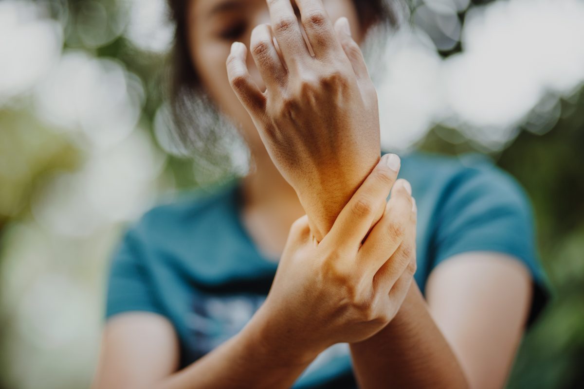 woman holding her wrist